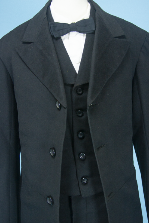 A photo of a three-piece black wool suit, circa 1860 to 1970